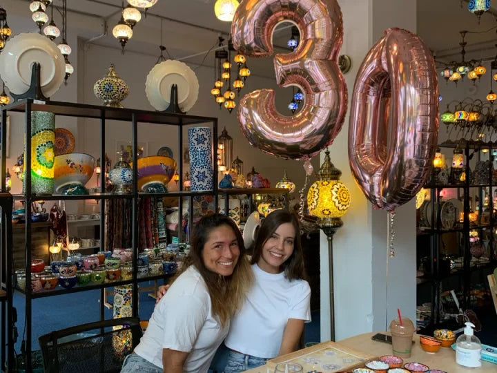 Birthday celebrations surrounded by mosaic lamps