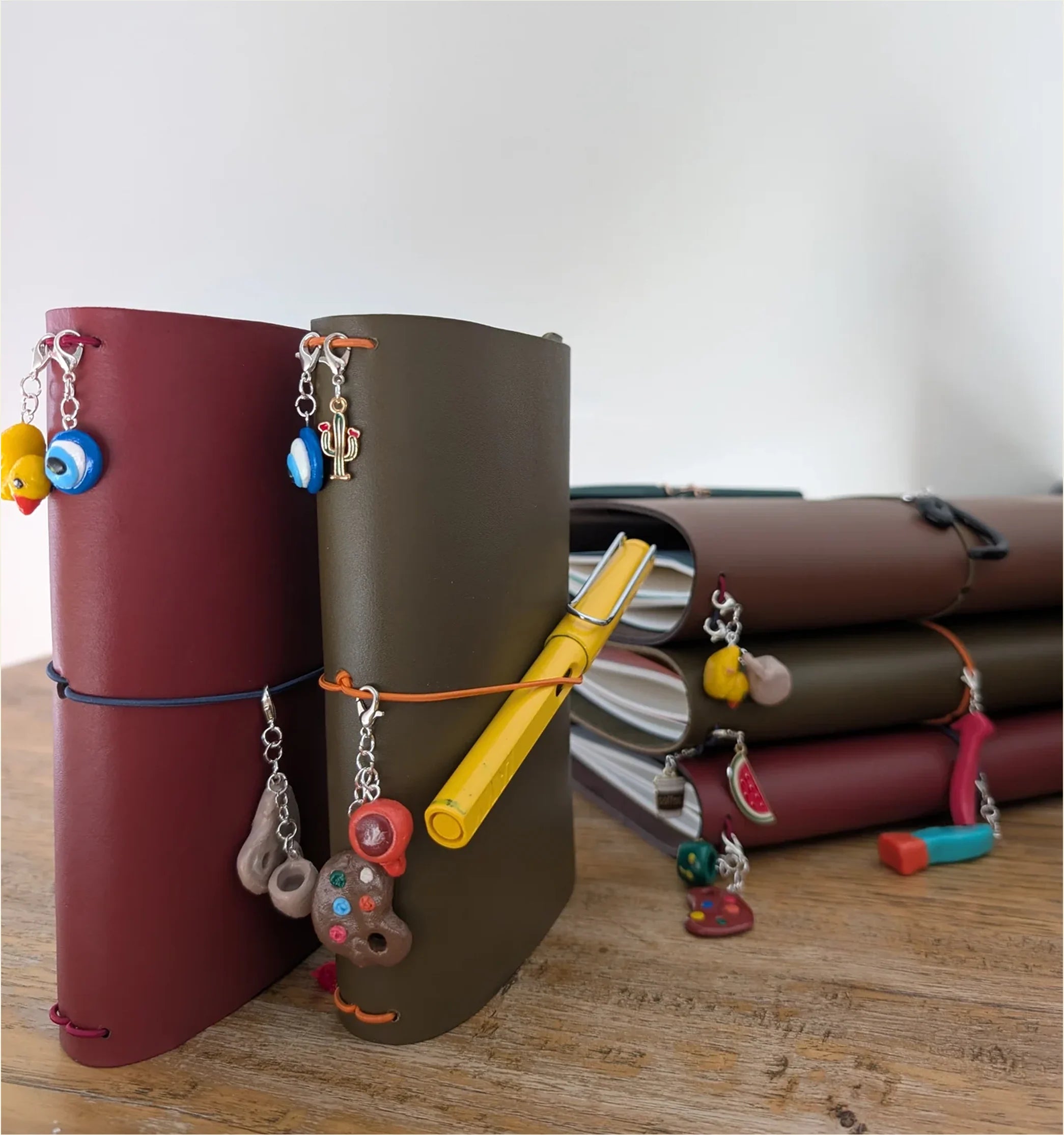 Handmade leather journals with cords and decorative charms