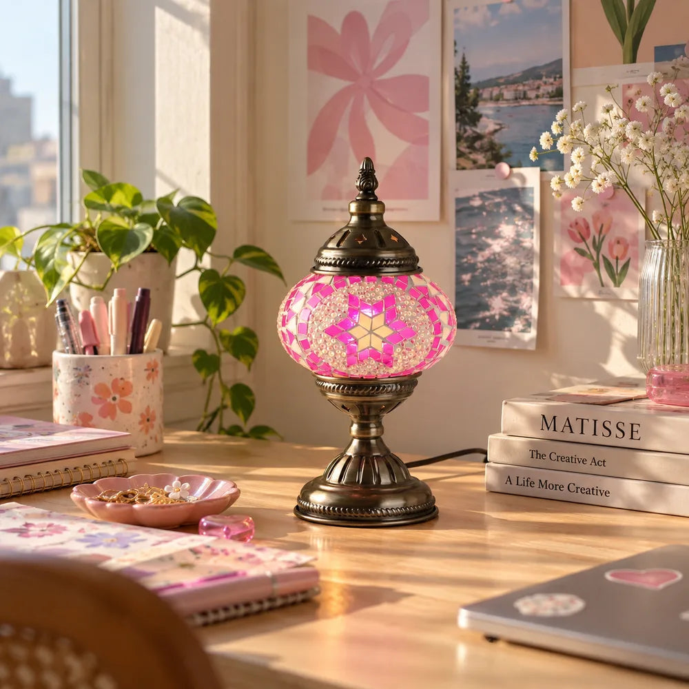 Pink mosaic table lamp beside a window