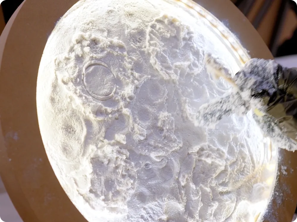 Detailed textured surface of a handmade moon artwork
